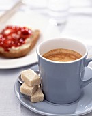 Coffee, sugar cubes, bread and jam