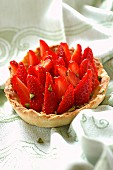 Individual strawberry, pistachio and lemon curd tart