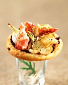 Individual flaky pastry tart filled with potatoes, onions and bacon
