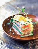 Piled cucumber and salmon slices