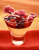 Glass of fruit with rose water and petals