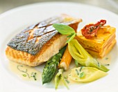Grilled salmon steak with vegetables and carrot flan