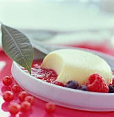 Entremets sweet dessert with summer fruit sauce