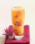 Orange juice with passionfruit flowers