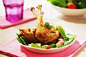 Roast chicken legs with sugar peas and diced bacon
