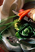 An arrangement of vegetables and silver cutlery