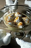 English cream with egg white dumplings and caramel sauce in a dessert glass