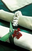 A white fabric napkin with a floral decoration