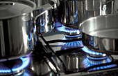 Gas stove with pans and blue flames