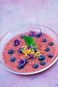Strawberry and blueberry coulis with violets