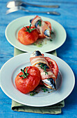 Sardines wrapped in bacon with preserved tomatoes