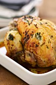 Roast chicken garnished with truffles and herbs