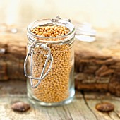 Small glass jar of mustard seeds