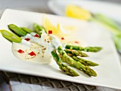 Green asparagus with creamy sauce and pepper