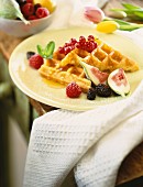 A waffle with fresh figs and berries