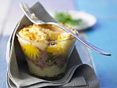 Duck and pineapple bake with a potato crust in a glass