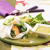 Trout with spinach sprouts cooked in parchment paper
