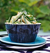 Penne salad with green vegetables and pine nuts