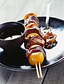 Duck and passion fruit skewers with a sweet and sour sauce