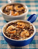 Small casserole dishes of seafood with mushrooms