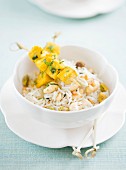 A chicken skewer and pilau rice with dried fruits