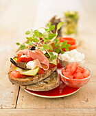 Sunny open sandwich with grilled vegetables,feta and raw ham