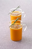 Glass cups of carrot soup