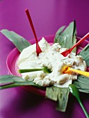Cream cheese on banana leave with colourful tasting spoons