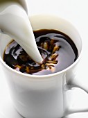 Adding milk to a cup of coffee