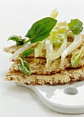 Crispy Parmesan and hazelnut cakes with spinach sprouts, celery and fennel