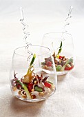 Sautéed squid, spring onions and broad beans with garlic served in glasses