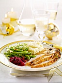 Slices of roast chicken breast,green beans,beetroot and mashed potatoes