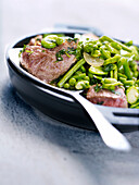 Cubes of lamb with green spring vegetables