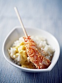 Pan-fried gambas with sesame seeds and risotto with curry sauce