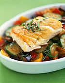 Piece of hake with summer vegetables