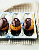 Madeleines coated with melted chocolate