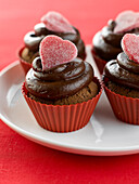 Chocolate cup cakes decorated with almond paste hearts