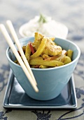 Chicken and pineapple cooked in a wok