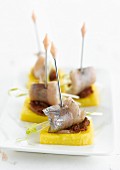 Polenta, tomato and herring appetizers
