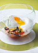 Poached egg with tomato, olives and capers