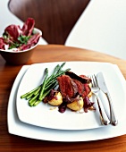 Grilled beef steak with red onion chutney and green asparagus