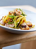 Tagliatelles with shrimps, crushed peanuts and scallion