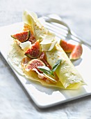 Rolled pancake filled with figs,parmesan and pancetta