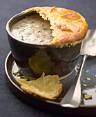 Cream of mushroom soup sealed with flaky pastry