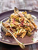 Spelt pasta sauteed with eggplants and artichokes