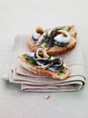 Anchovies with herbs on sliced bread