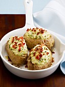 Baked potatoes in their jackets with chives and raw ham
