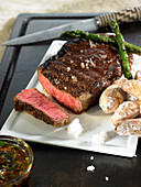 Grilled thick beef steak ,Chimichurri  and herb sauce