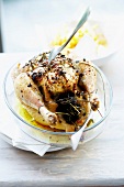 Roast chicken with herbs cooked in a casserole dish and French fries
