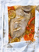 Sea bream with lime,tomatoes and pepper cooked in wax paper